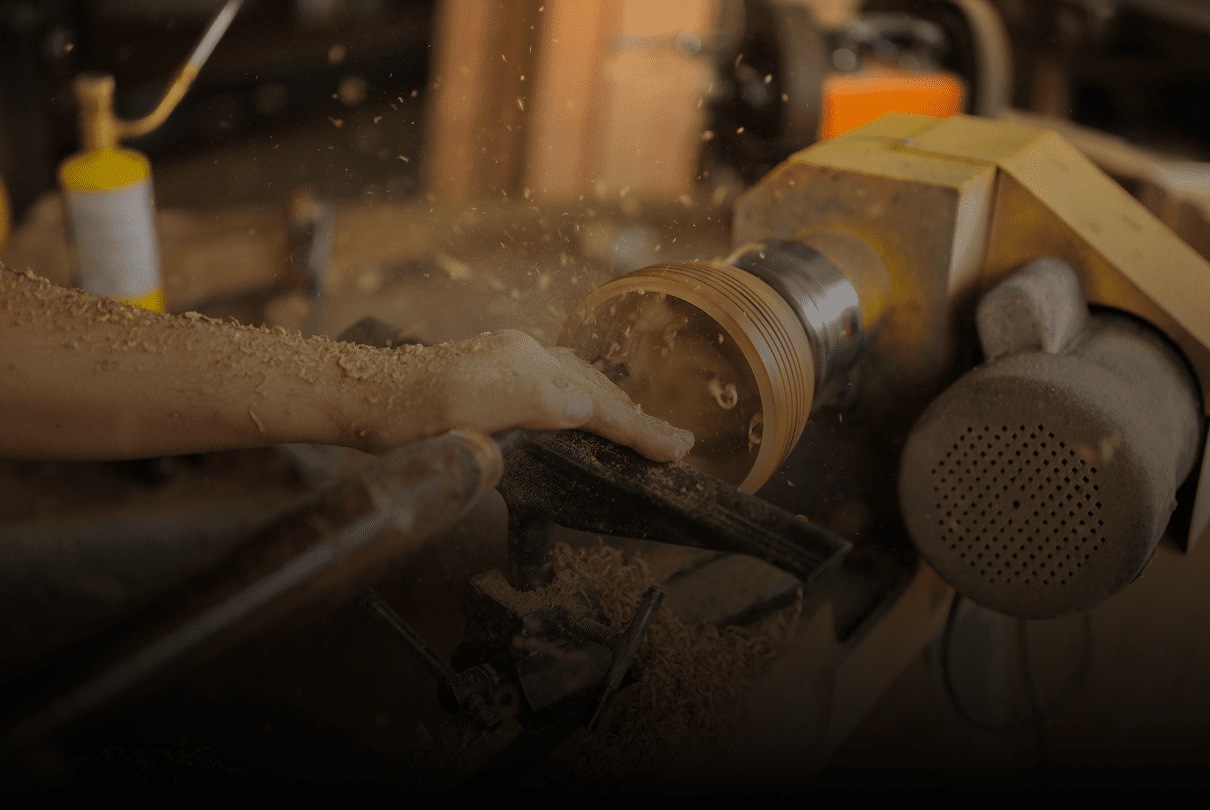 Wood shavings flying from lathe work.